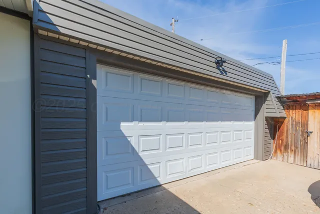 a view of a backyard with wooden fence