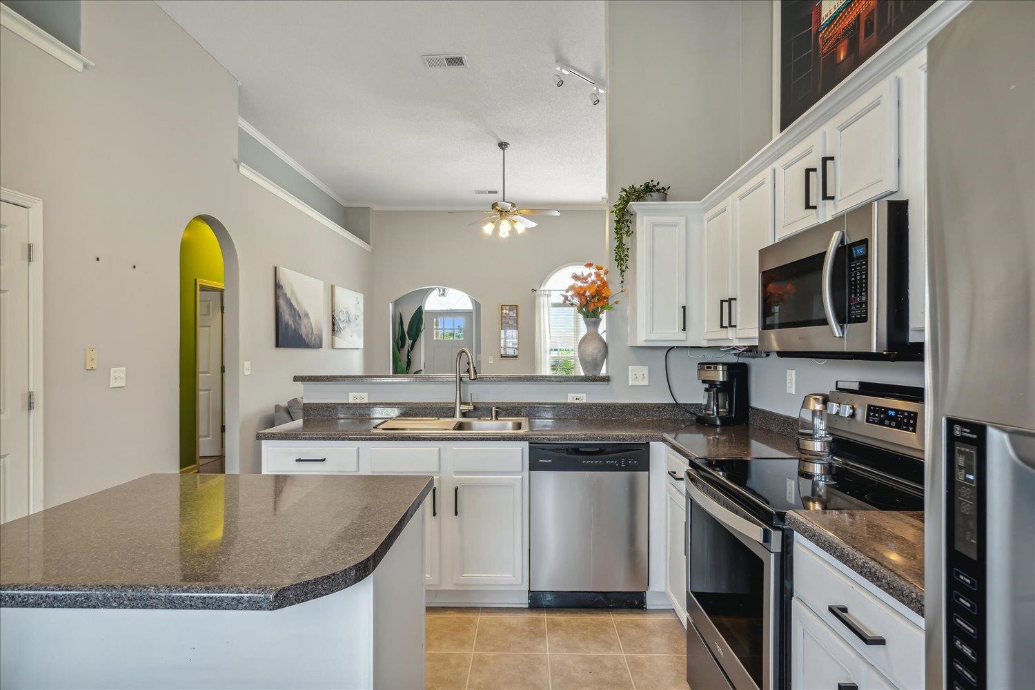 5003 Will Fall Lane Bartlett, TN 38002 - Photo 11 of 26 a kitchen with stainless steel appliances granite countertop a sink a stove and cabinets