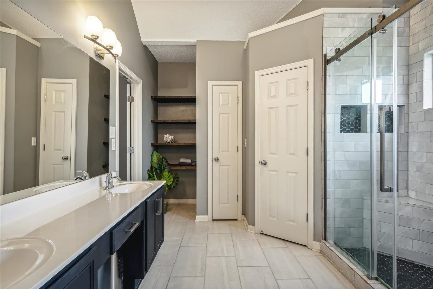 5003 Will Fall Lane Bartlett, TN 38002 - Photo 16 of 26 a bathroom with a double vanity sink and a mirror