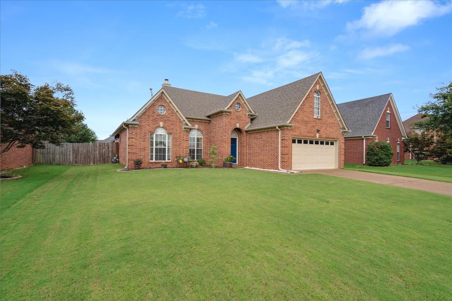 5003 Will Fall Lane Bartlett, TN 38002 - Photo 2 of 26 a front view of a house with a garden and yard