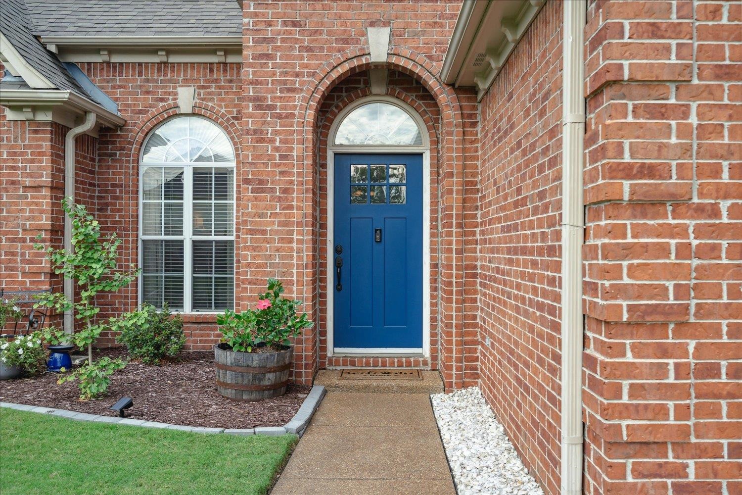 5003 Will Fall Lane Bartlett, TN 38002 - Photo 3 of 26 a view of a brick house with a large windows and a flower plants