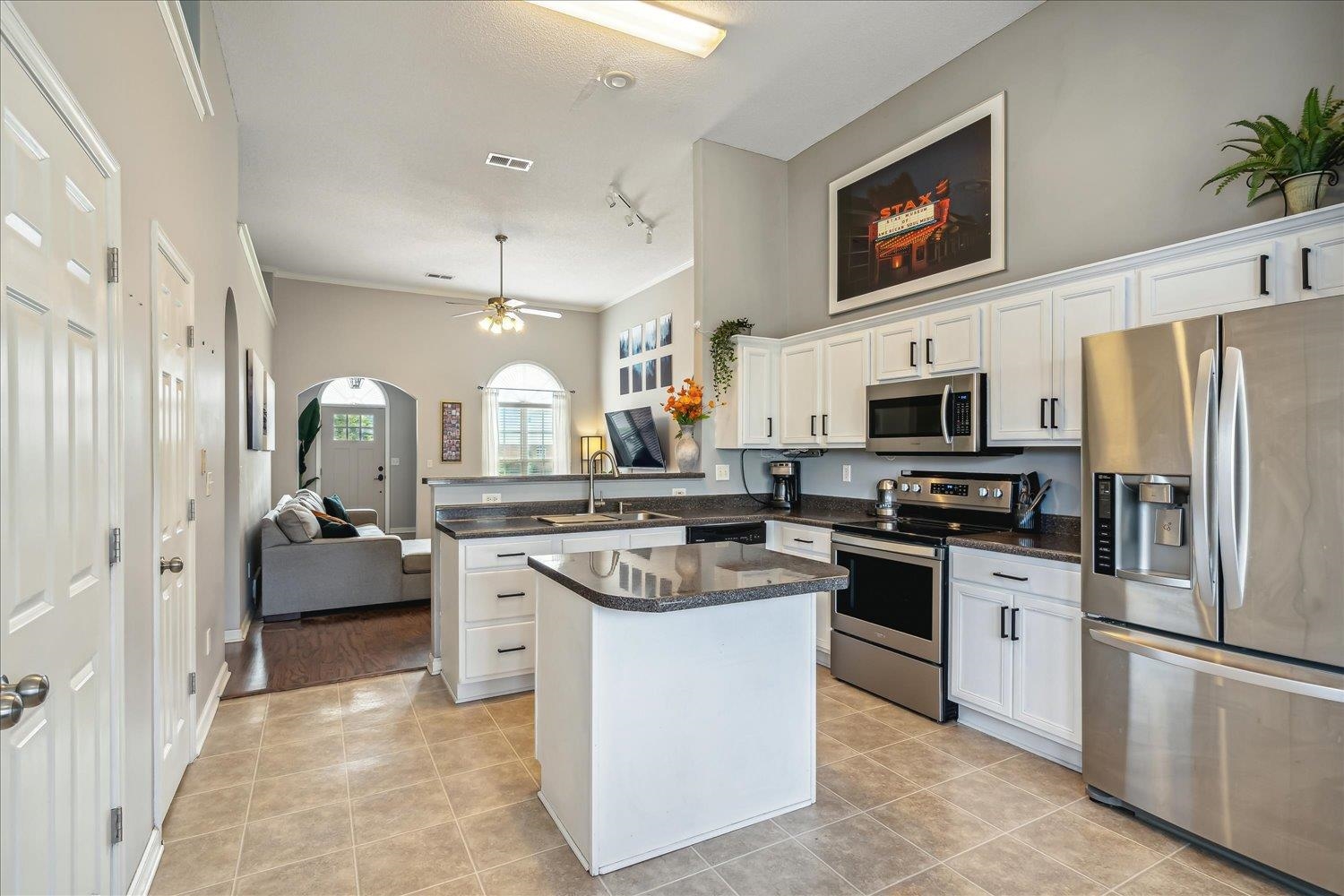 5003 Will Fall Lane Bartlett, TN 38002 - Photo 10 of 26 a kitchen with stainless steel appliances granite countertop a stove top oven a refrigerator a sink and dishwasher with white cabinets