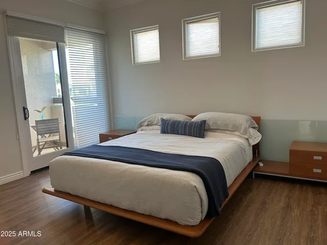 a room with gym equipment and large windows