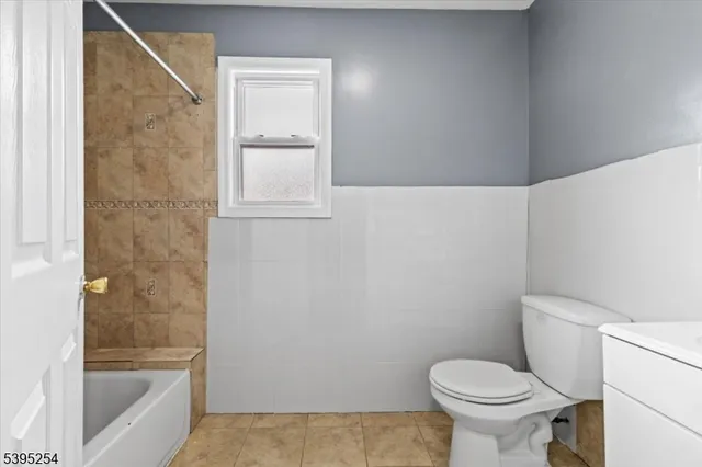 a bathroom with a toilet and a bathtub