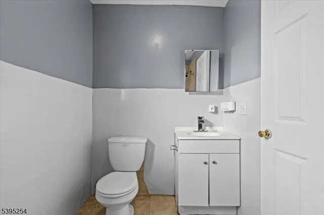 a bathroom with a sink mirror and toilet