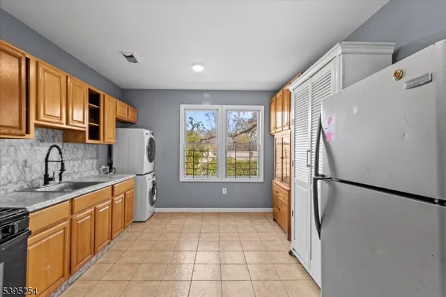 a kitchen with stainless steel appliances granite countertop a refrigerator sink and cabinets