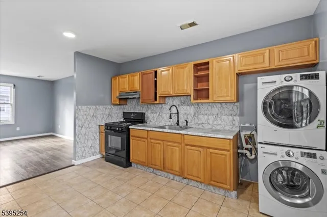 a view of a kitchen with sink washer and dryer