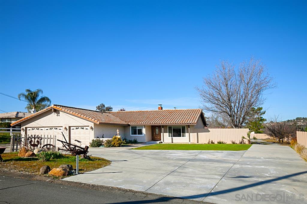Large circular driveway and with easy access to rear yard, Guest House, carport and RV Hookups!