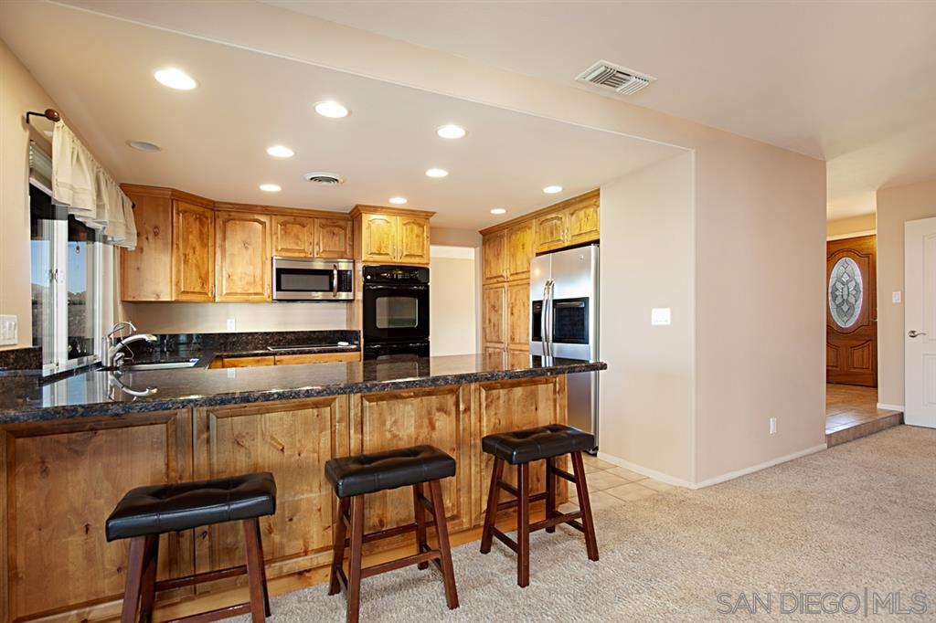 1774 Roble Grande Road Alpine, CA 91901 - Photo 11 of 25 Granite counters, custom cabinets, breakfast bar, recessed lights and lots of light.