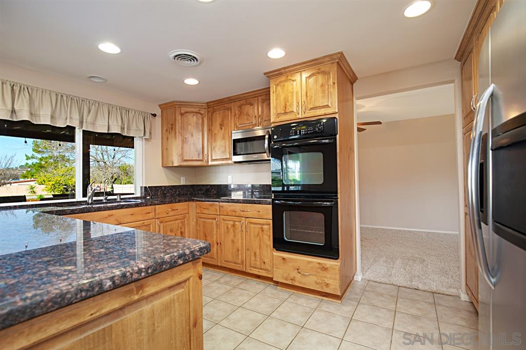 1774 Roble Grande Road Alpine, CA 91901 - Photo 12 of 25 Granite counters, custom cabinets, breakfast bar, recessed lights and lots of light.