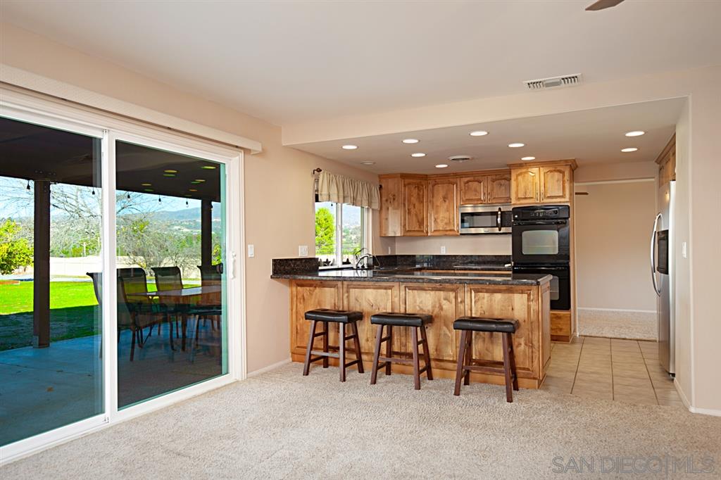1774 Roble Grande Road Alpine, CA 91901 - Photo 13 of 25 Granite counters, custom cabinets, breakfast bar, recessed lights and lots of light.
