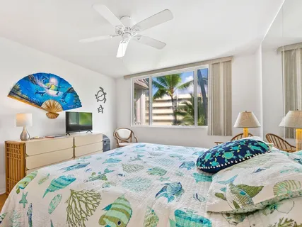 a bedroom with a bed and a painting on the wall