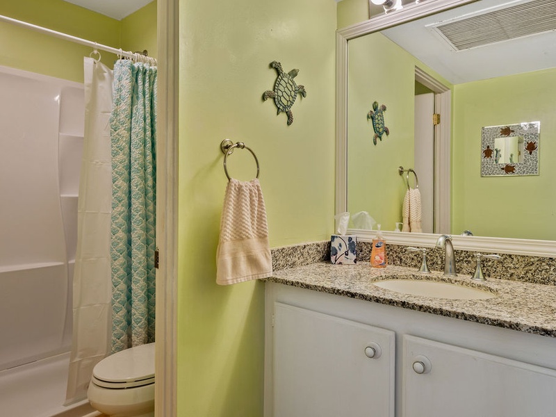 75-5870 Kahakai Road, Unit 409 Kailua-Kona, HI 96740 - Photo 16 of 16 a bathroom with a granite countertop sink toilet and shower