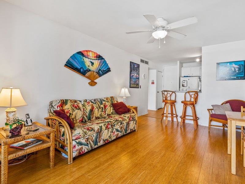 75-5870 Kahakai Road, Unit 409 Kailua-Kona, HI 96740 - Photo 2 of 16 a living room with furniture and wooden floor