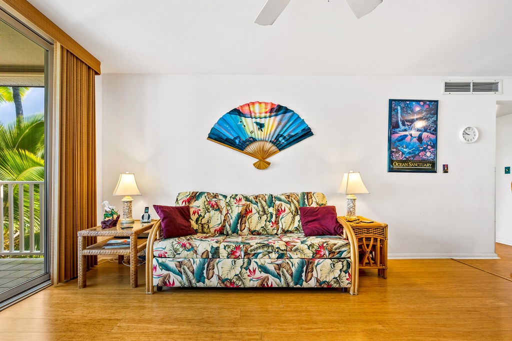 75-5870 Kahakai Road, Unit 409 Kailua-Kona, HI 96740 - Photo 3 of 16 a living room with furniture and painting on the wall