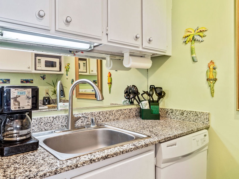 75-5870 Kahakai Road, Unit 409 Kailua-Kona, HI 96740 - Photo 7 of 16 a kitchen with a sink and a stove