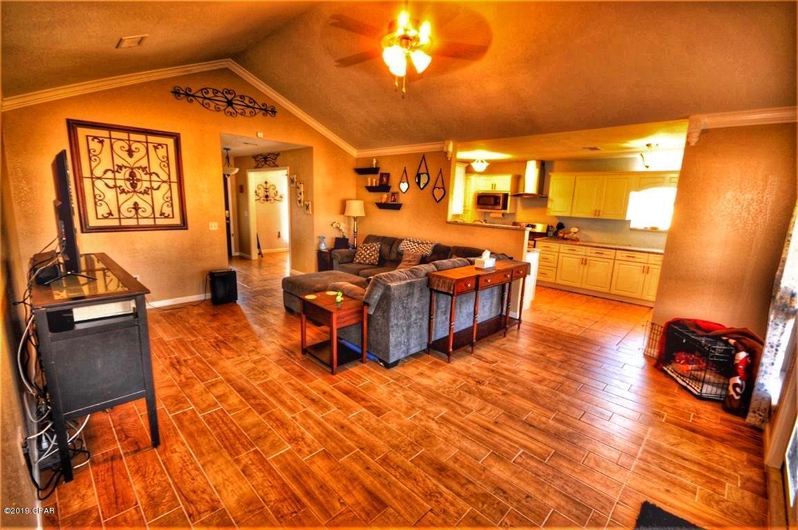 2905 Cedars Crossing Panama City, FL 32405 - Photo 2 of 11 a living room with furniture and a flat screen tv