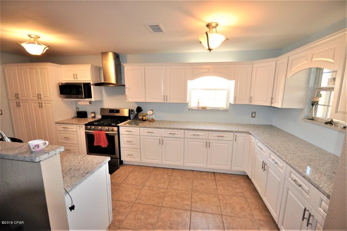 2905 Cedars Crossing Panama City, FL 32405 - Photo 3 of 11 a kitchen with a sink window and cabinets
