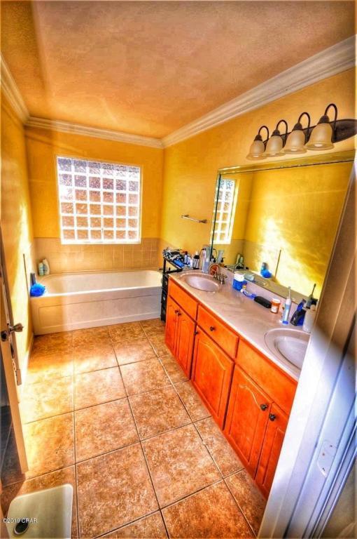 2905 Cedars Crossing Panama City, FL 32405 - Photo 4 of 11 a bathroom with a tub sink and mirror