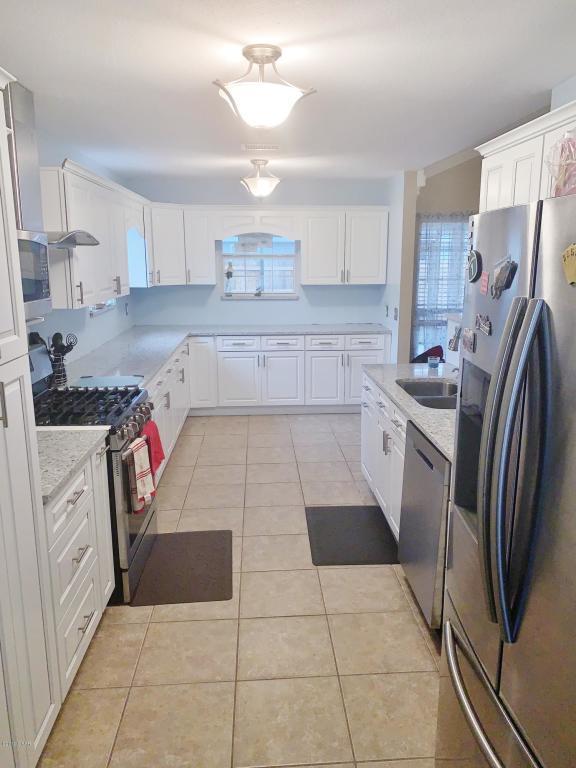 2905 Cedars Crossing Panama City, FL 32405 - Photo 10 of 11 a kitchen with stainless steel appliances granite countertop a sink and cabinets