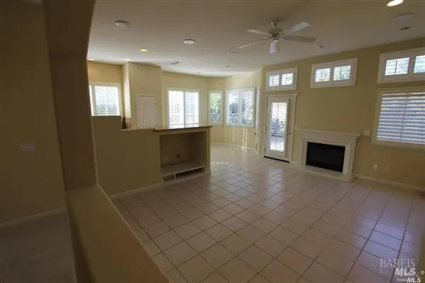 a view of an empty room with a fireplace and a window