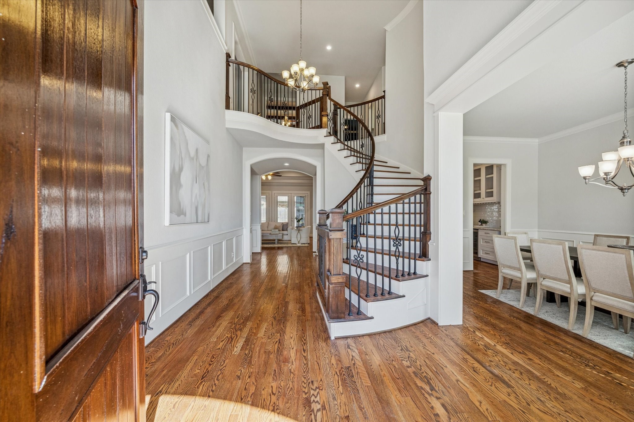 1802 Wakefield Drive Houston, TX 77018 - Photo 7 of 47 Light-filled foyer featuring a graceful curved staircase and open sightlines that welcome guests in style.