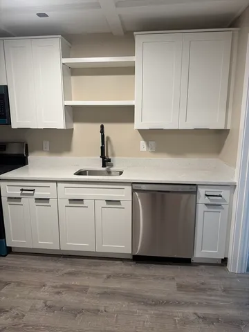 a kitchen with white cabinets and white appliances