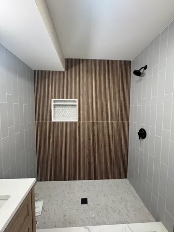 a bathroom with a shower and a sink