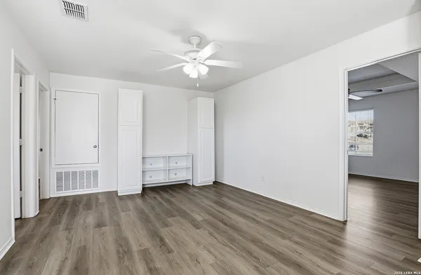 a view of empty room with wooden floor