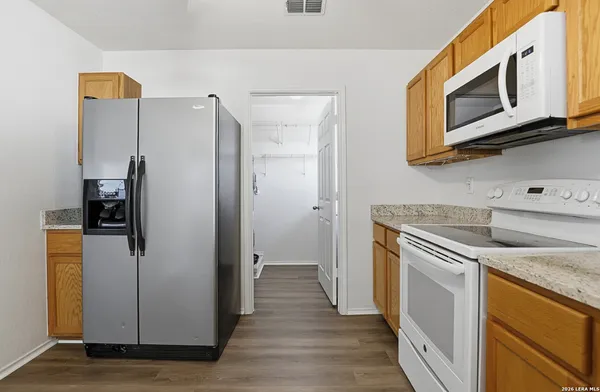 a kitchen with stainless steel appliances granite countertop a refrigerator and a microwave
