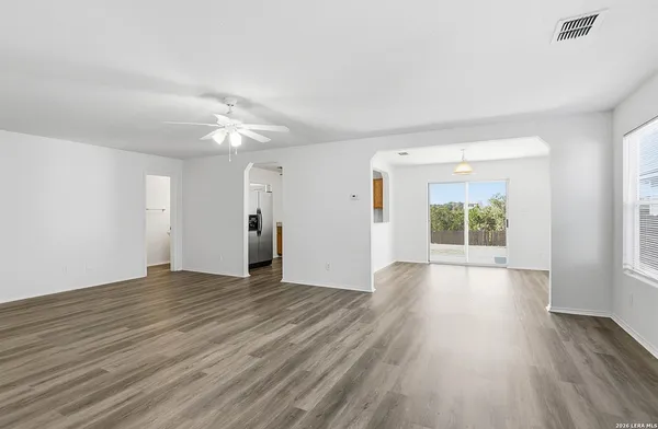 wooden floor in an empty room with a window