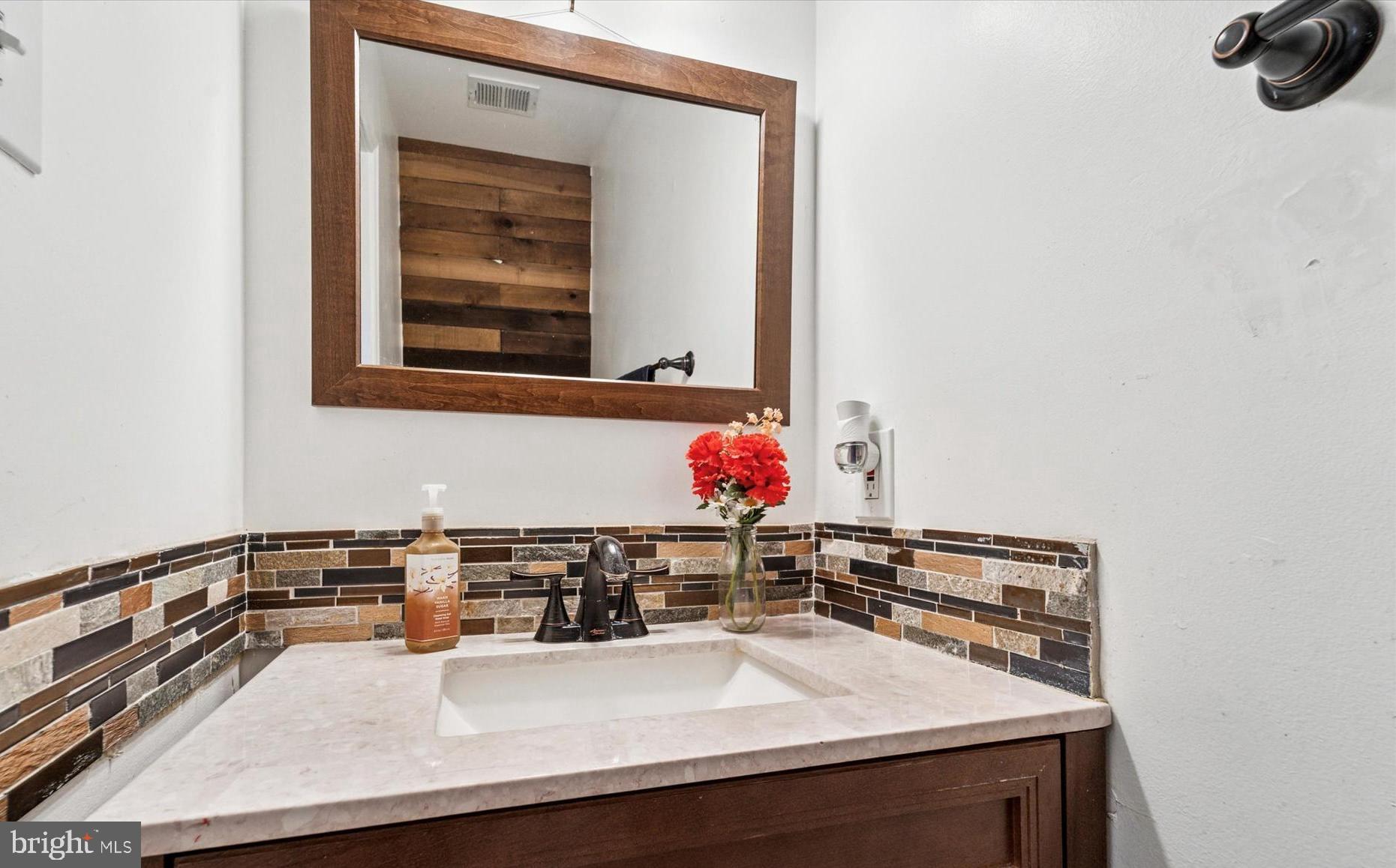 31 Ashley Court, Unit 31 Glen Mills, PA 19342 - Photo 9 of 19 a bathroom with a sink and a mirror