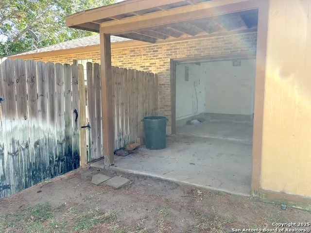 a view of a backyard with wooden fence