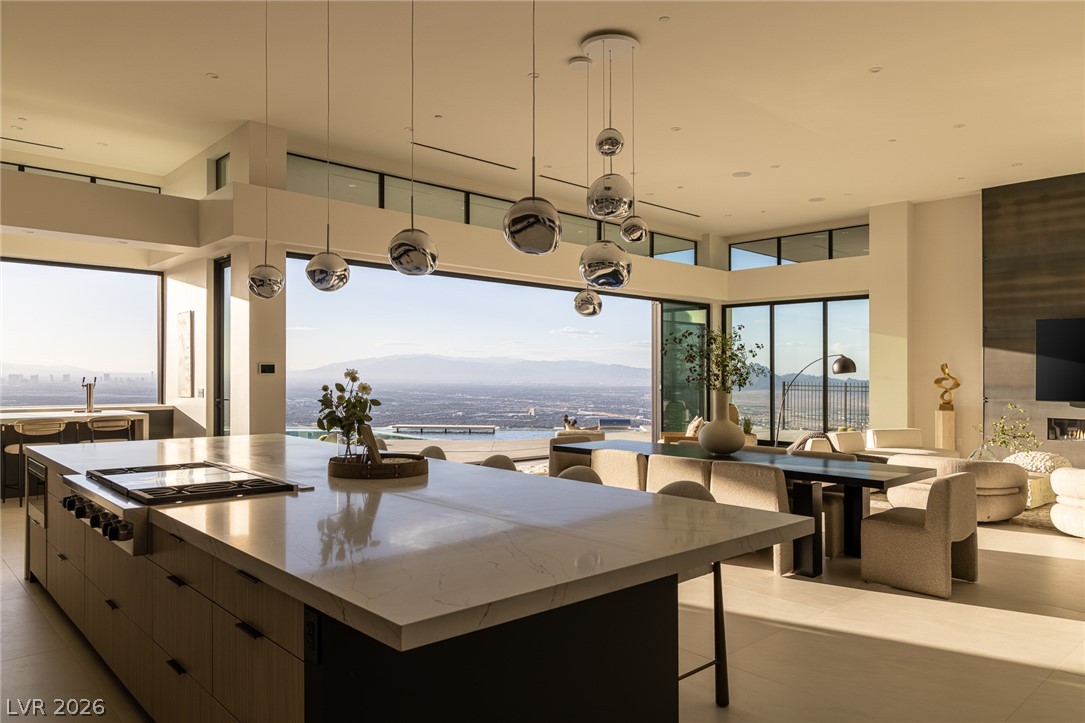 563 Grand Rim Drive Henderson, NV 89012 - Photo 11 of 70 An open-concept living area offers panoramic city and mountain views from expansive windows.
