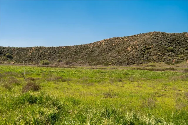 a view of a field with a view of mountains