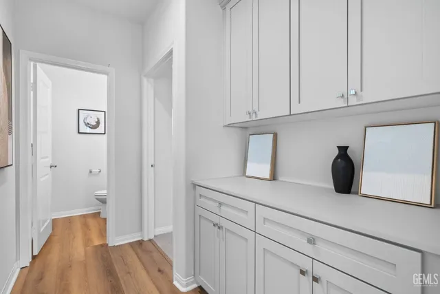 a large white kitchen with a sink and a stove top oven