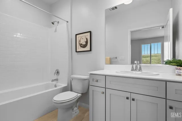 a bedroom with two beds and potted plant