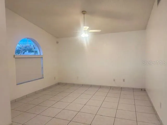 an empty room with white walls and cabinet