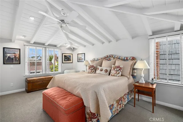 a bedroom with a large bed couch and a window