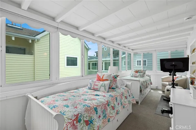 a bedroom with bed couch and window
