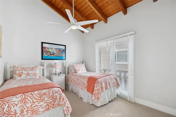 a bedroom with two beds and a window