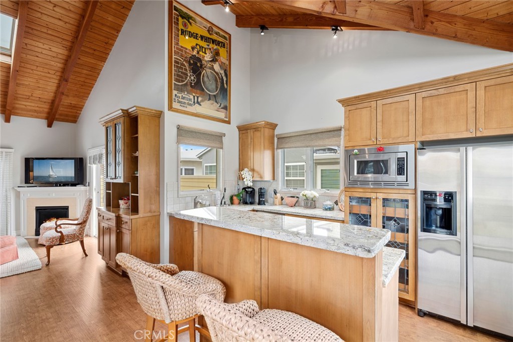112 Abalone Avenue Newport Beach, CA 92662 - Photo 21 of 25 a living room with stainless steel appliances granite countertop furniture a fireplace and a kitchen view