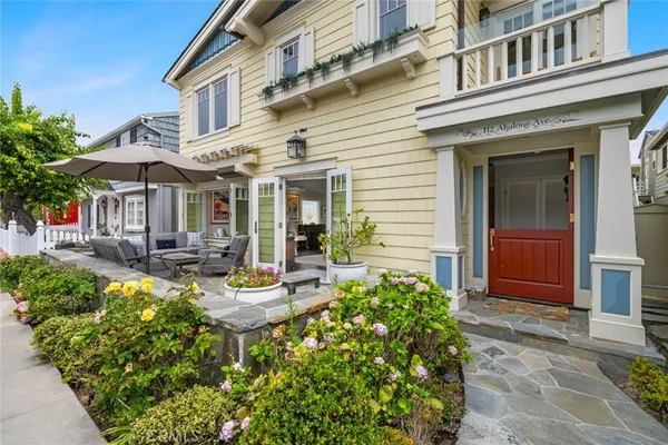 a view of a house with sitting area and garden