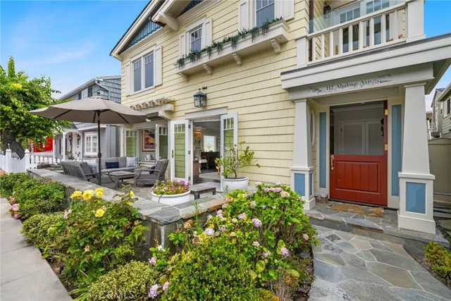 a view of a house with sitting area and garden