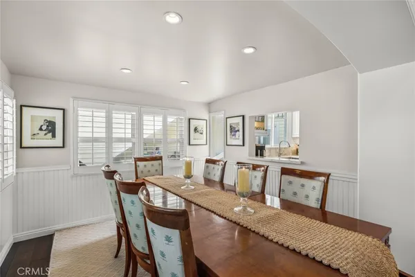 a view of a dining room with furniture and a window