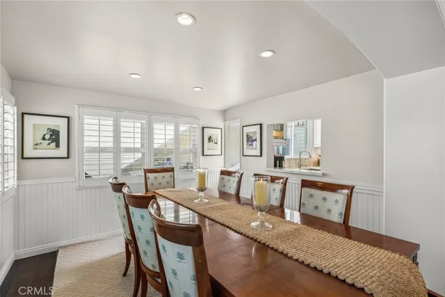 a view of a dining room with furniture and a window