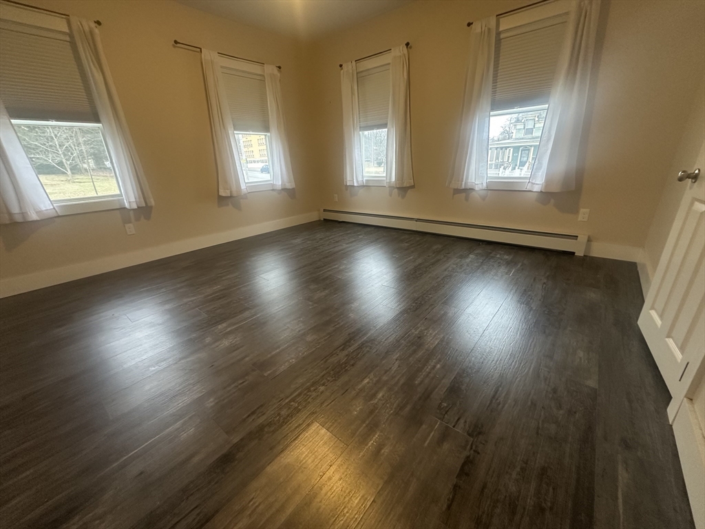 105 Elm Street, Unit 1 Gardner, MA 01440 - Photo 1 of 9 a view of room with window and wooden floor