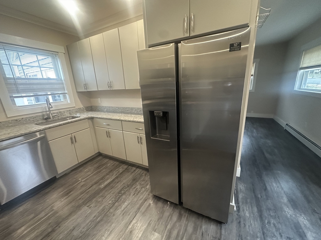 105 Elm Street, Unit 1 Gardner, MA 01440 - Photo 6 of 9 a kitchen with stainless steel appliances a refrigerator sink and cabinets