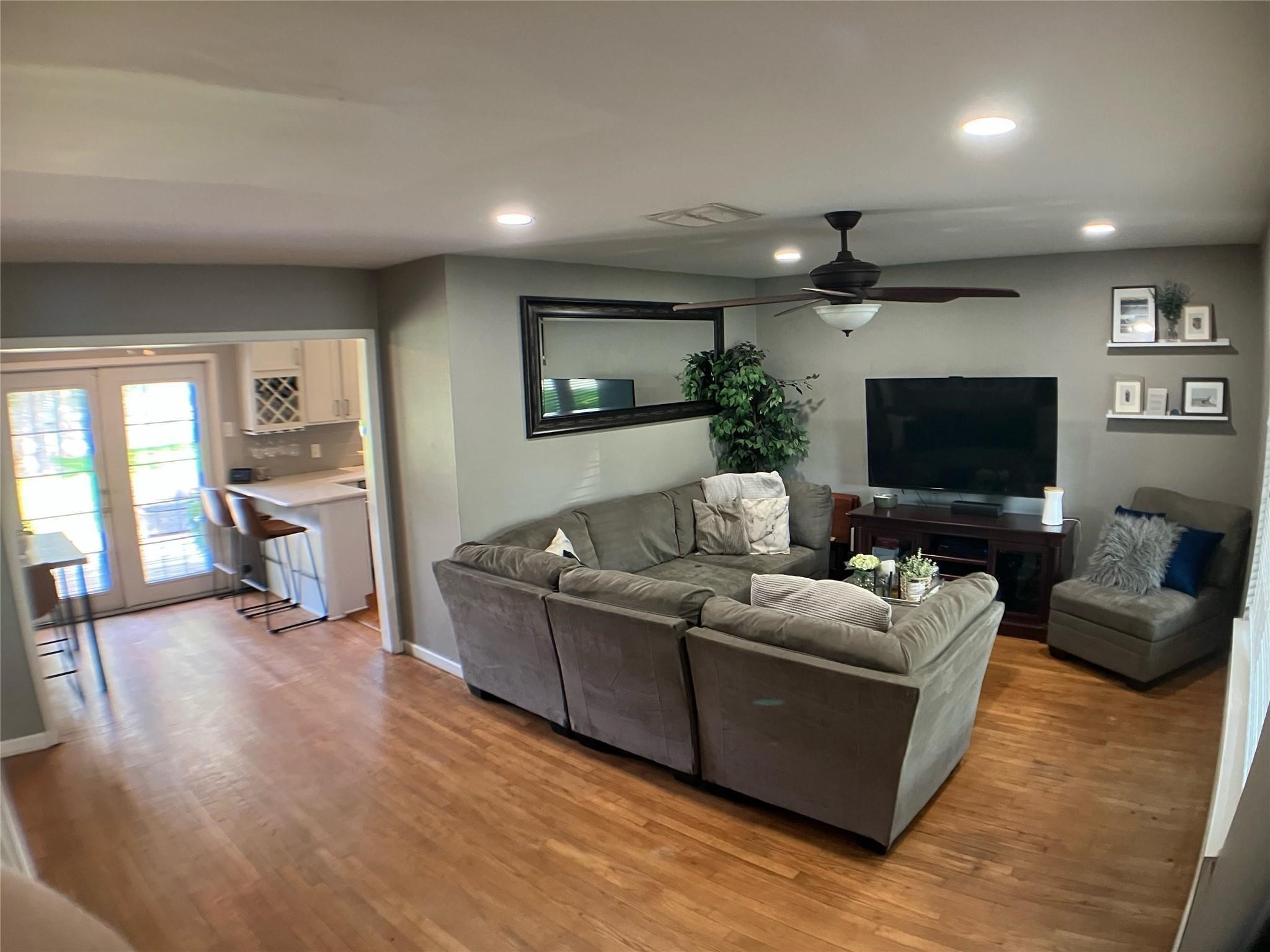 3027 Guese Road Houston, TX 77018 - Photo 9 of 22 Inviting living room offers an open layout with updated flooring and a comfortable atmosphere for entertaining.
