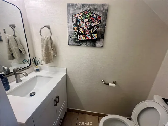 a bathroom with a sink mirror and toilet
